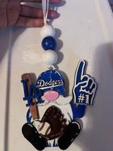 Decorative ornament with Dodgers logo, glove, and foam finger on a white background